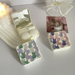 Estuche para lentes de contacto de colores con conejitos coloridos